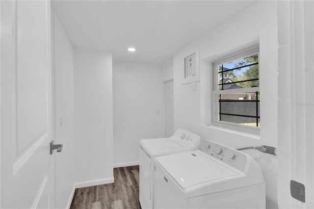 laundry area featuring washing machine and dryer and light hardwood / wood-style floors