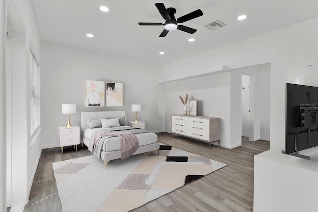 bedroom with ceiling fan and dark hardwood / wood-style floors