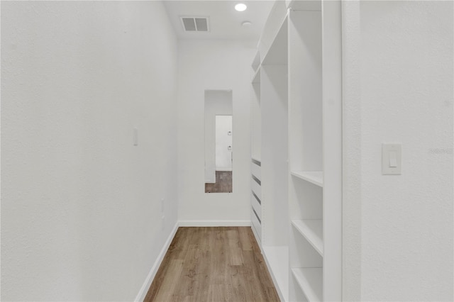 spacious closet with light hardwood / wood-style flooring