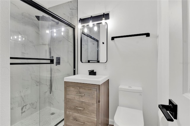 bathroom featuring a shower with shower door, vanity, and toilet