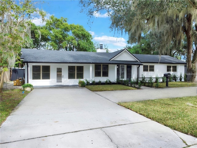 245 W George Ave, Maitland, FL 32751 - ranch-style home featuring concrete driveway, a front lawn, a chimney, and stucco siding