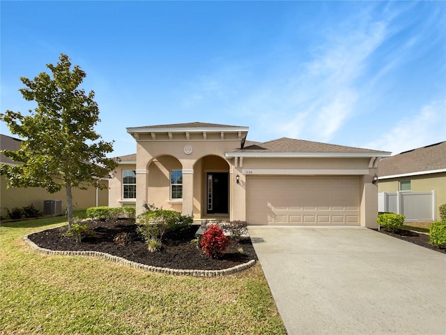 view of front of house with central AC unit, a garage, and a front yard