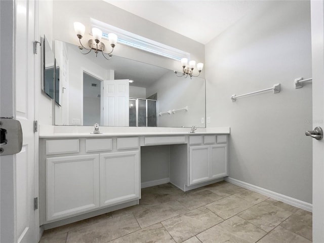 bathroom featuring a shower with door, vanity, and an inviting chandelier