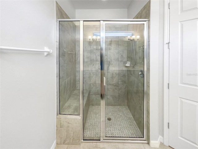 bathroom featuring a shower with door and tile patterned floors