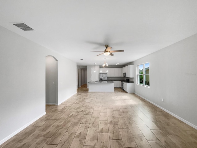 unfurnished living room with ceiling fan and light hardwood / wood-style flooring