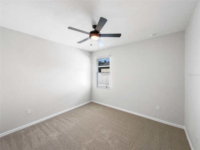 spare room with carpet flooring and ceiling fan