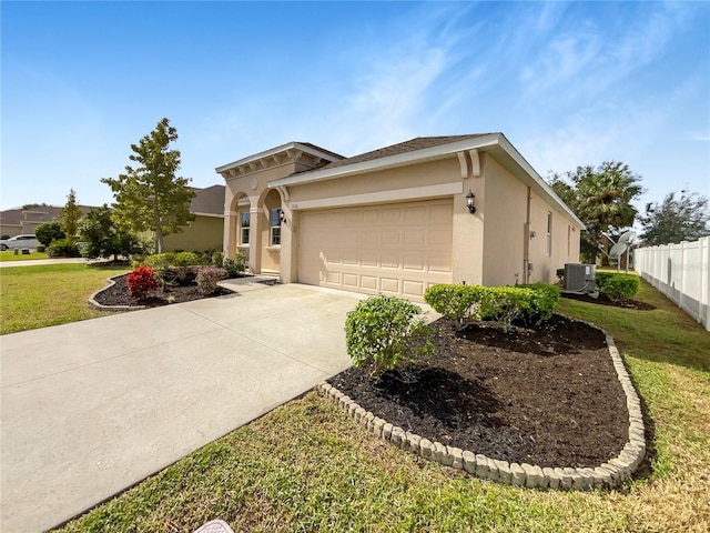 view of front of home with a front lawn, a garage, and central AC