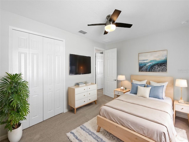 carpeted bedroom with a closet and ceiling fan