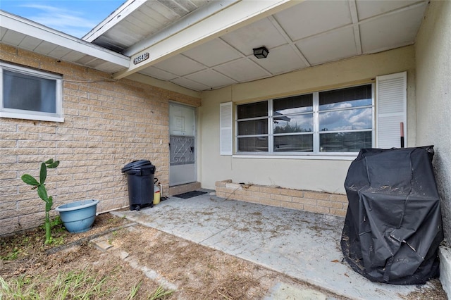 entrance to property featuring a patio area