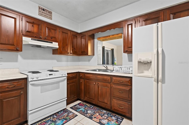 kitchen with sink, white appliances, and light tile patterned flooring