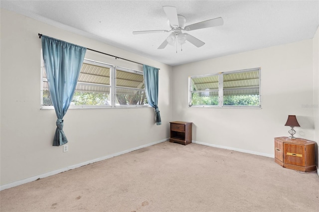 spare room with light carpet and ceiling fan