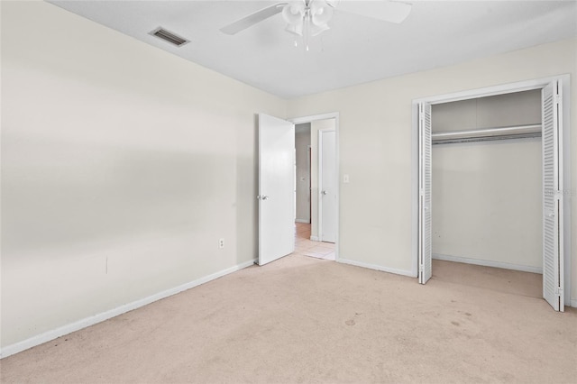 unfurnished bedroom featuring ceiling fan, a closet, and light colored carpet