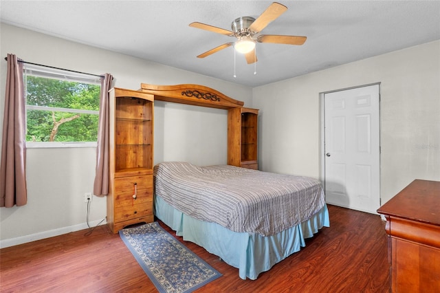 bedroom with dark wood-type flooring and ceiling fan