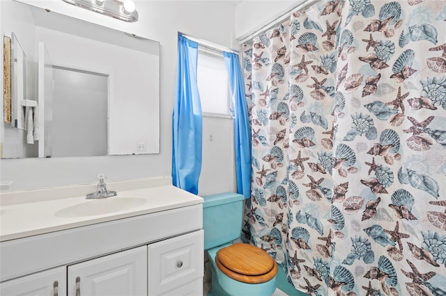 bathroom featuring toilet, vanity, and walk in shower