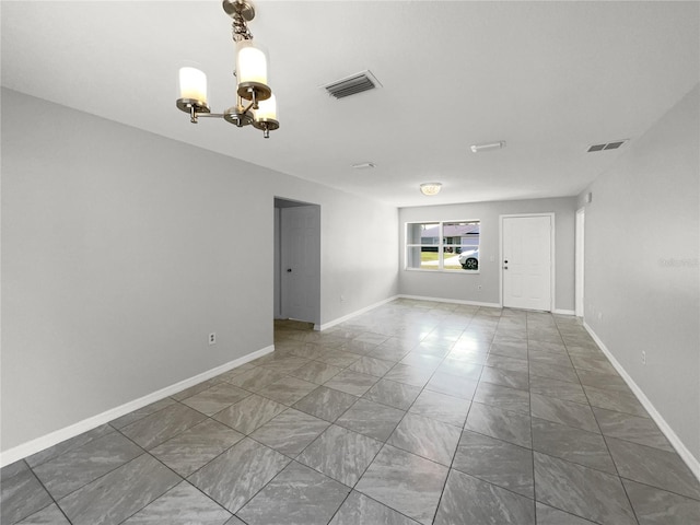 empty room with an inviting chandelier