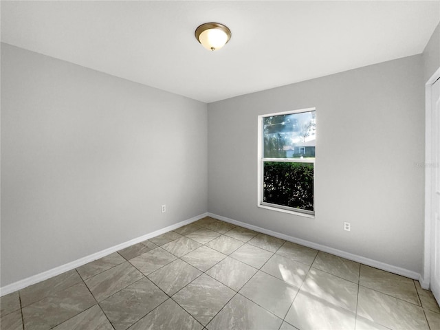 unfurnished room featuring tile patterned flooring