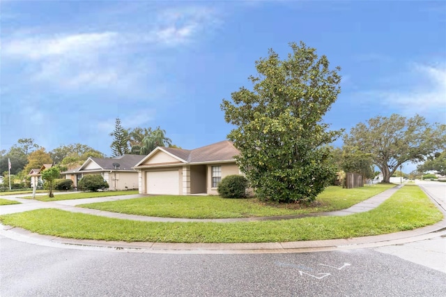 view of front of property featuring a garage and a front yard