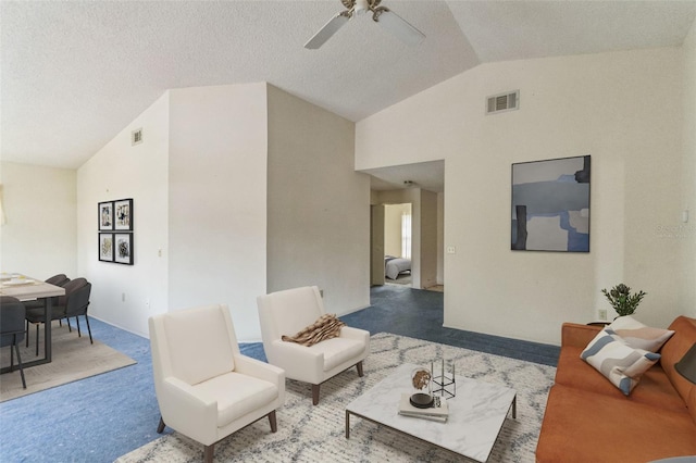 living room featuring carpet, ceiling fan, lofted ceiling, and a textured ceiling