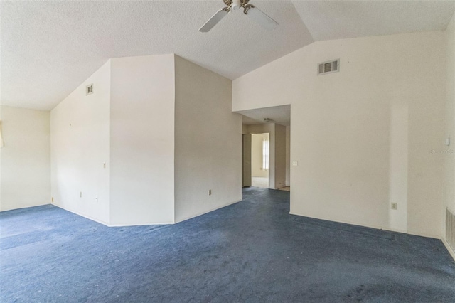 spare room featuring a textured ceiling, dark carpet, ceiling fan, and lofted ceiling