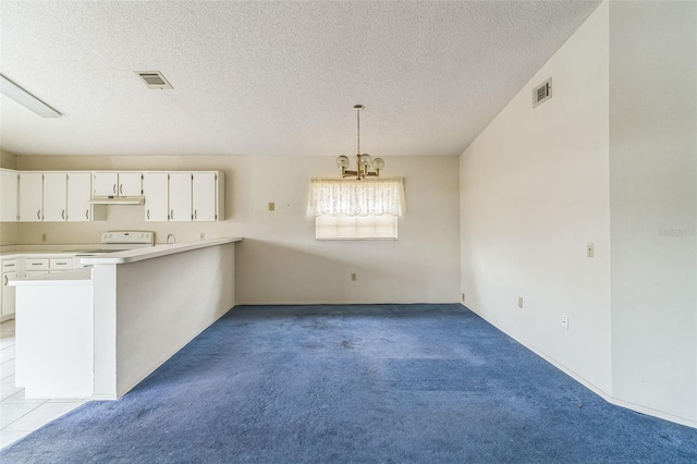 kitchen with pendant lighting, light colored carpet, white cabinetry, and a chandelier