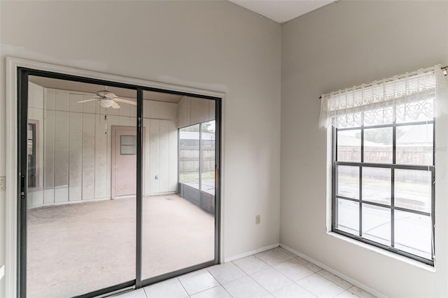 unfurnished bedroom featuring ceiling fan, light tile patterned flooring, and multiple windows