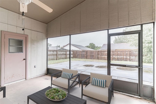 sunroom / solarium featuring ceiling fan and vaulted ceiling