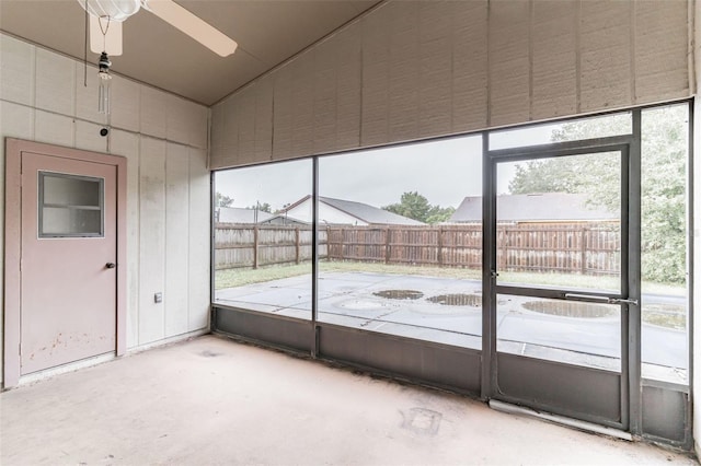 unfurnished sunroom featuring ceiling fan and vaulted ceiling