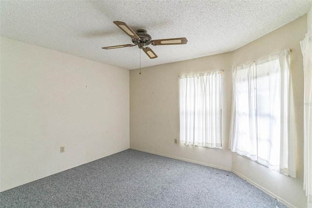 carpeted empty room featuring a textured ceiling and ceiling fan