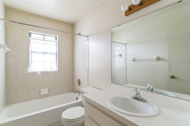 full bathroom featuring vanity, tiled shower / bath combo, and toilet