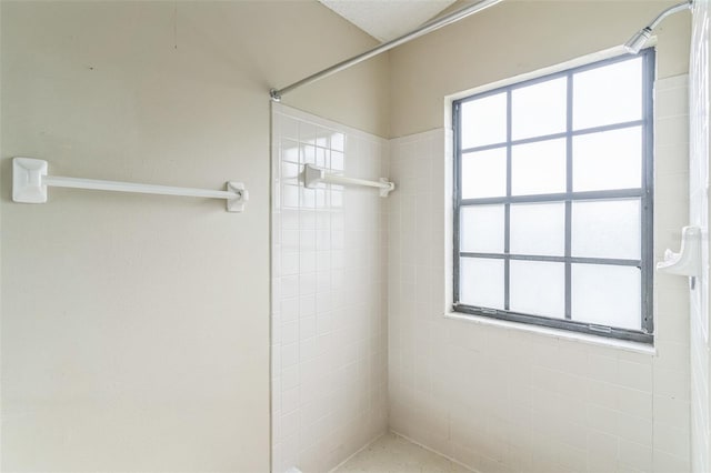 bathroom with tiled shower