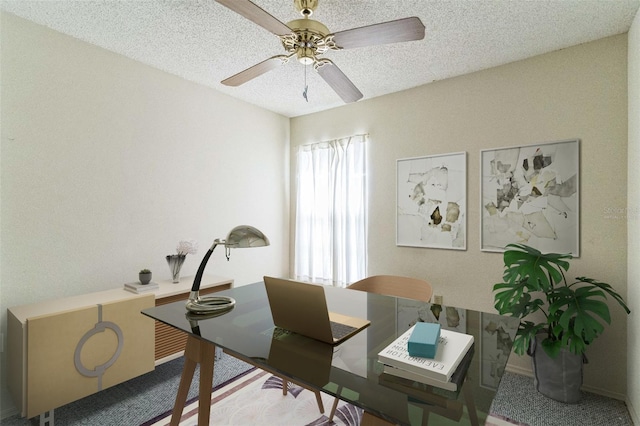 carpeted office space with ceiling fan and a textured ceiling