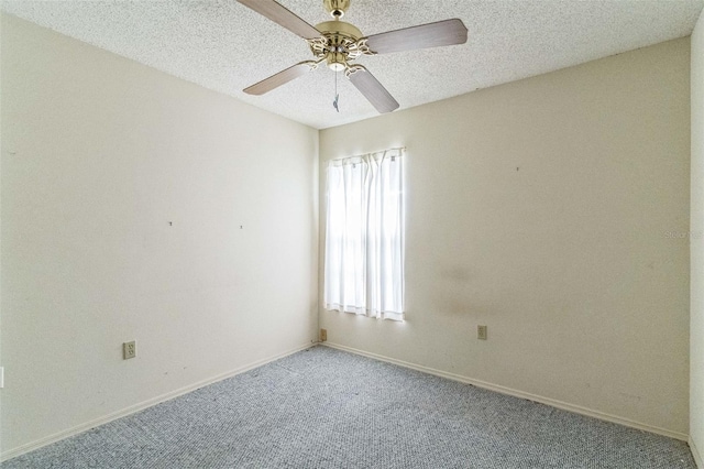 carpeted empty room with ceiling fan and a textured ceiling