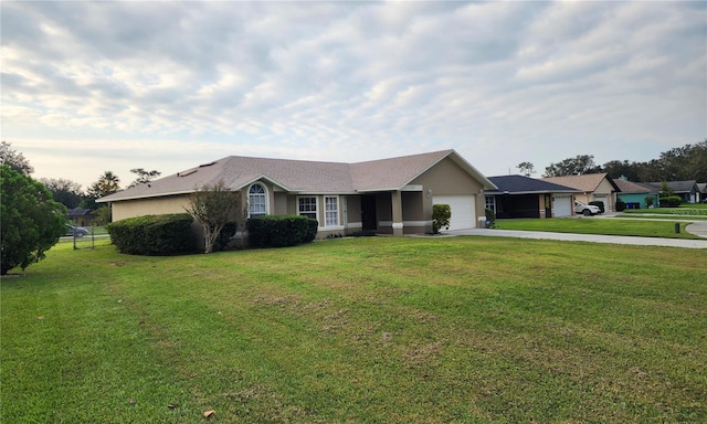 ranch-style house featuring a garage and a front yard