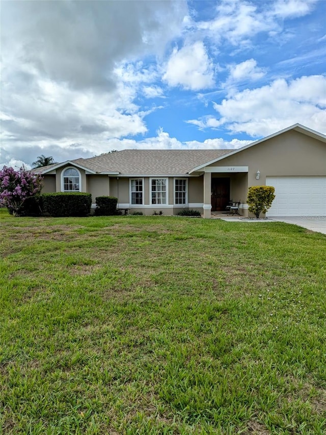 single story home with a garage and a front yard