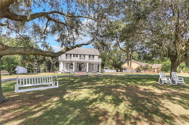 back of house with a yard and covered porch