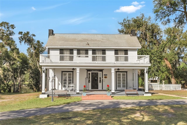 view of front of home featuring ceiling fan, a balcony, french doors, and a porch