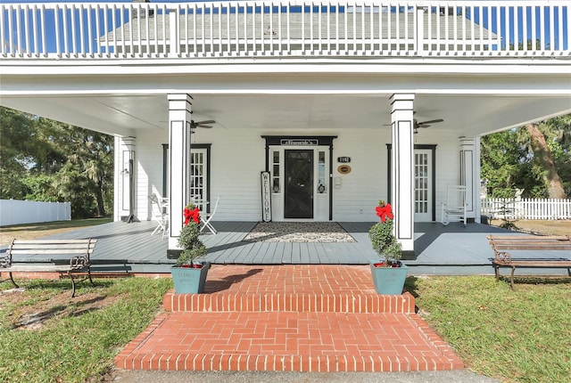 entrance to property featuring ceiling fan and a balcony