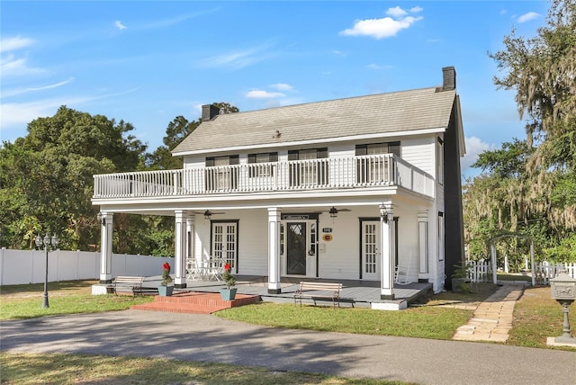 view of front of home featuring a balcony, ceiling fan, and a porch