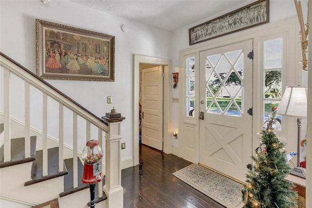 entrance foyer featuring dark hardwood / wood-style floors and a textured ceiling