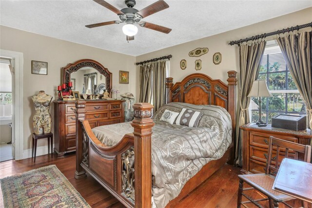 bedroom featuring dark hardwood / wood-style flooring, a textured ceiling, and ceiling fan