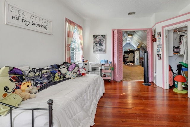 bedroom with dark hardwood / wood-style flooring