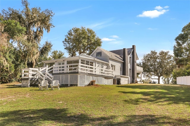 view of side of home with a wooden deck and a yard