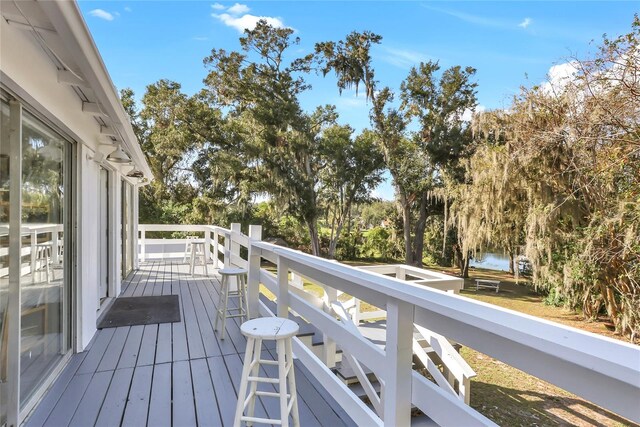 wooden terrace featuring a water view