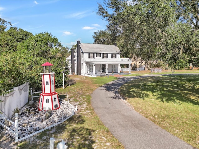 view of front of property with a front yard and covered porch