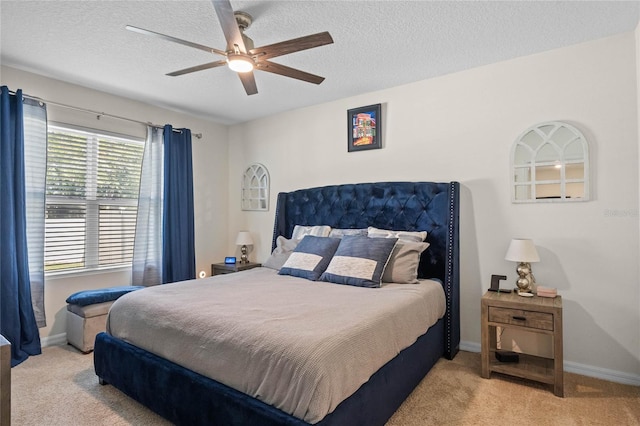 carpeted bedroom with a textured ceiling and ceiling fan