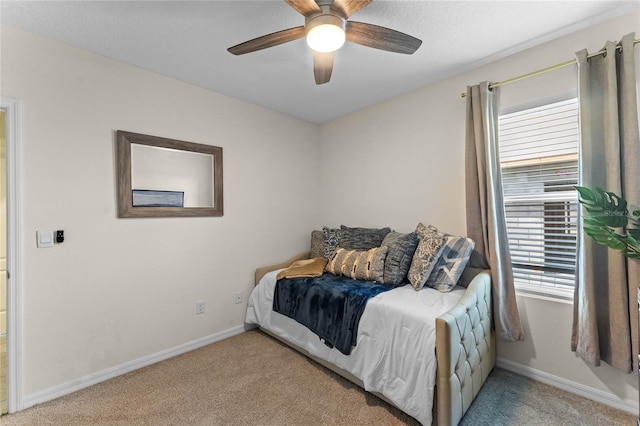 bedroom featuring light colored carpet and ceiling fan