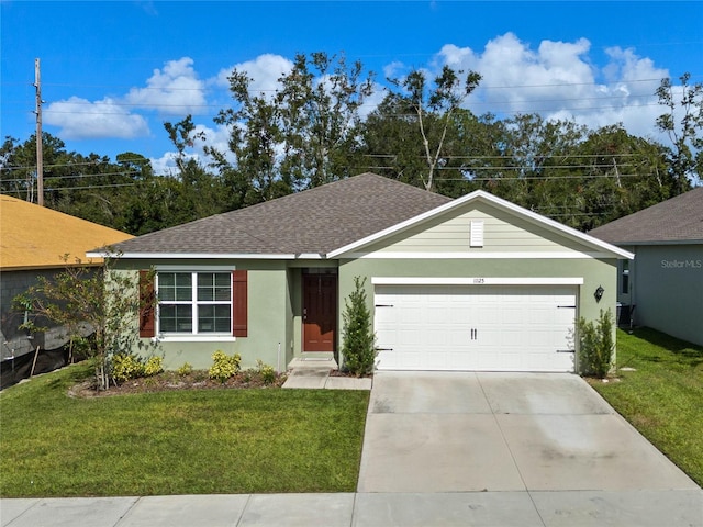 ranch-style house with a garage, central AC unit, and a front yard