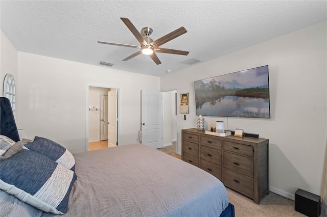 carpeted bedroom featuring a textured ceiling and ceiling fan