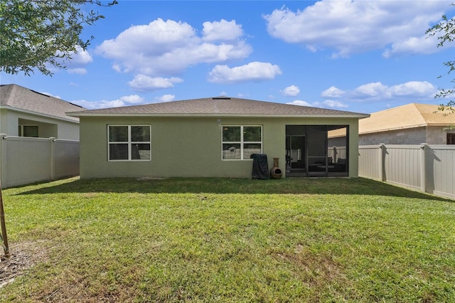 back of house featuring a lawn