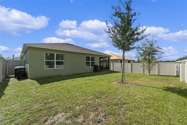 back of house featuring a lawn